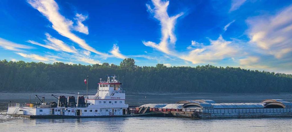 Towboat driving a barge on the river