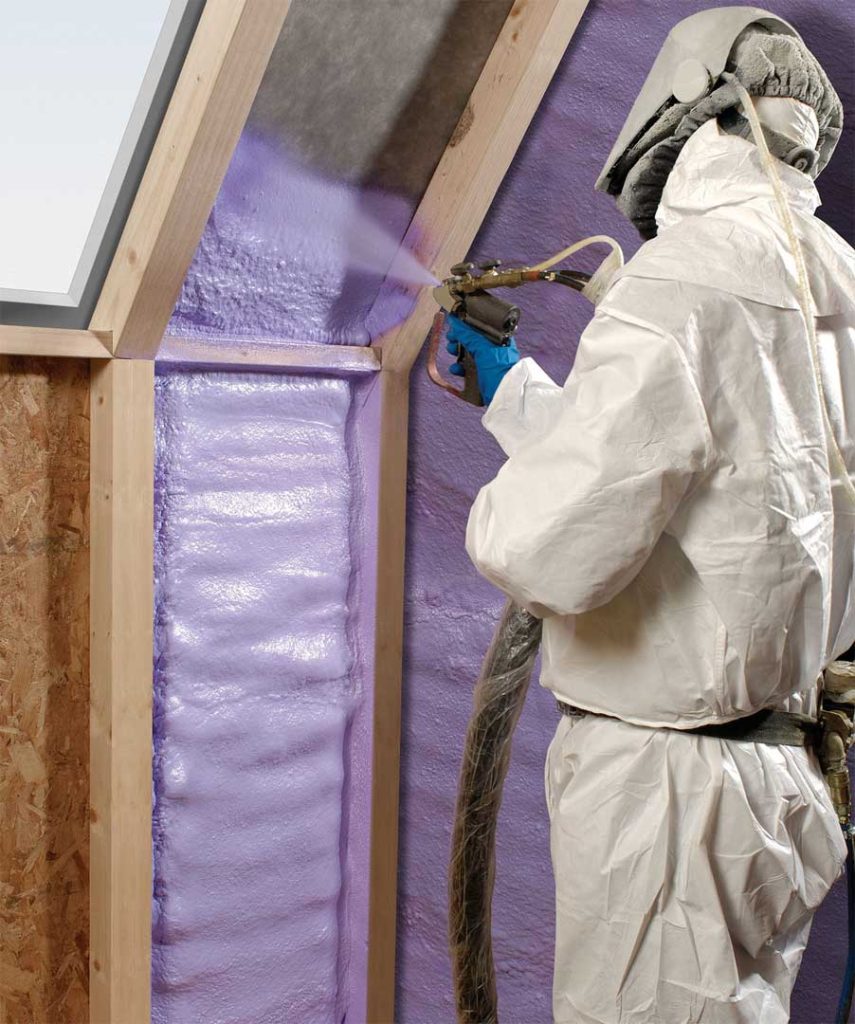 Man spraying insulation in walls